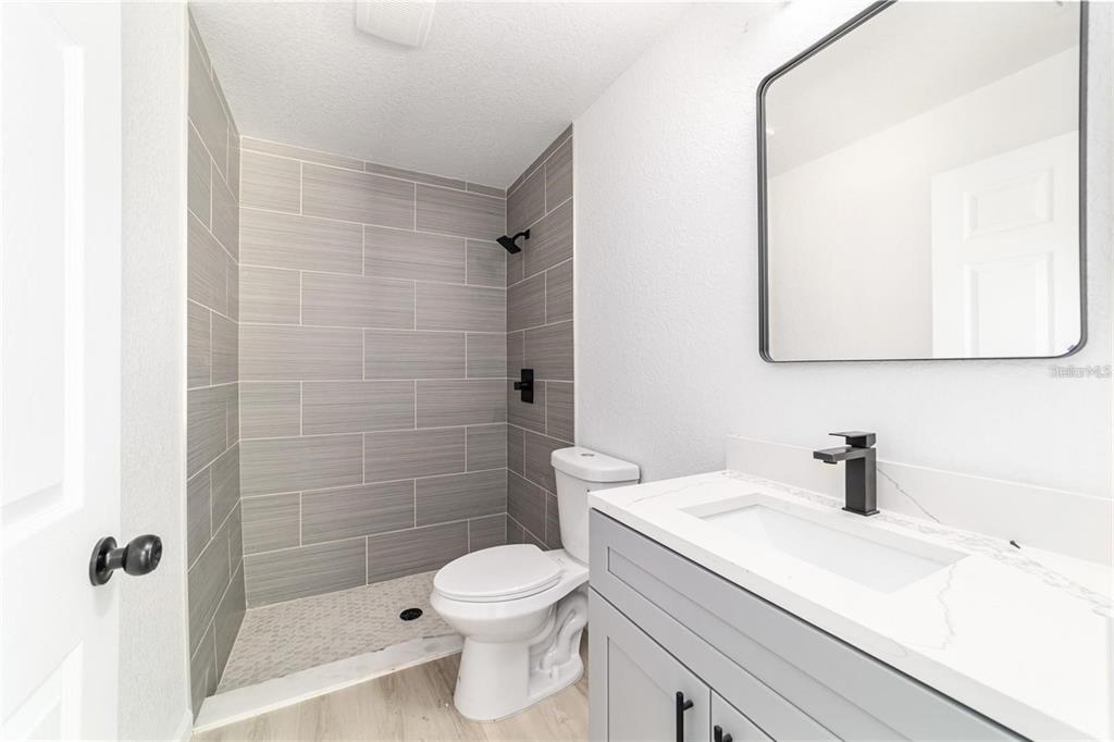 13310 Southwest 11th Street Road Ocala, FL 34481 - Photo 25 of 35 a bathroom with a sink a toilet and shower