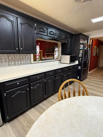 a kitchen with granite countertop a sink and cabinets