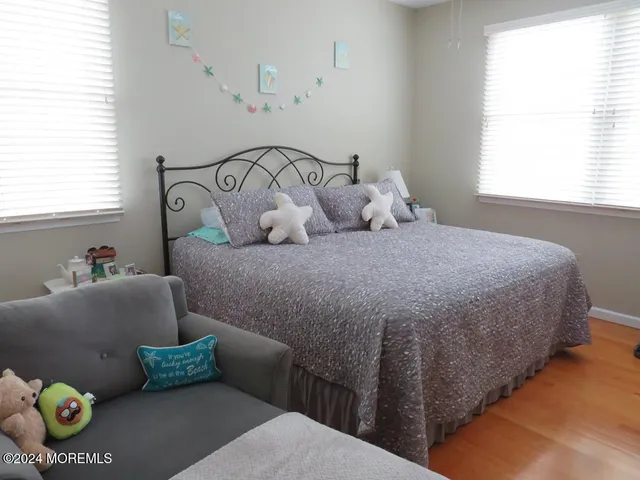 a bedroom with a bed and windows