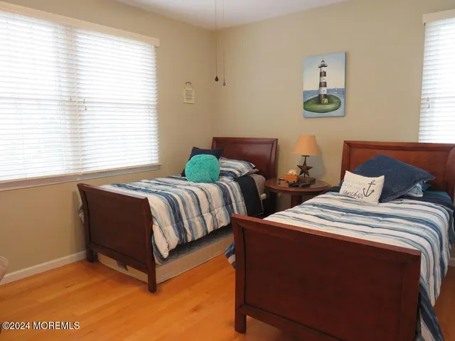 a bedroom with two beds and a window