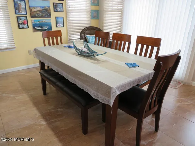 a view of a dining room with furniture and a window