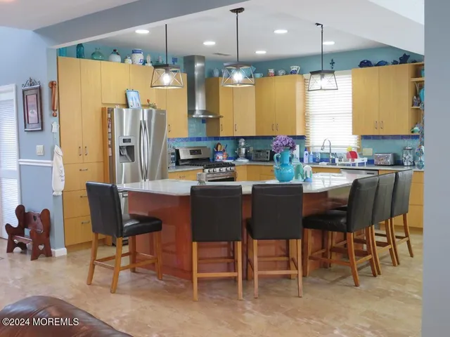 a large kitchen with a table and chairs
