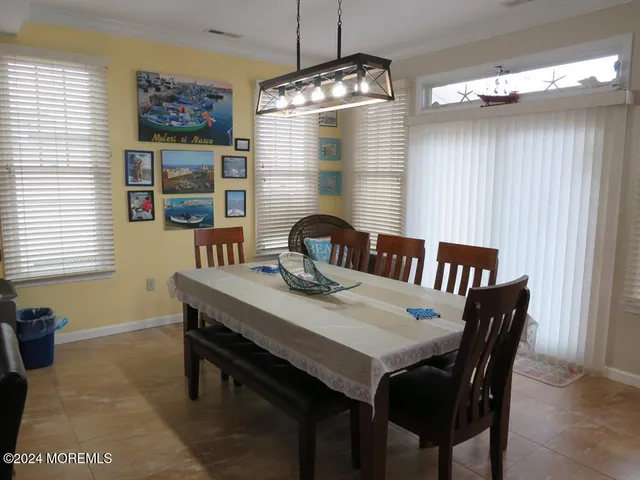 a view of a dining room with furniture and window