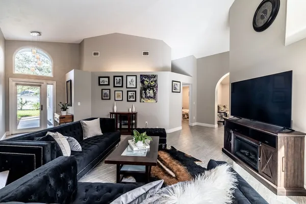 a living room with furniture and a flat screen tv