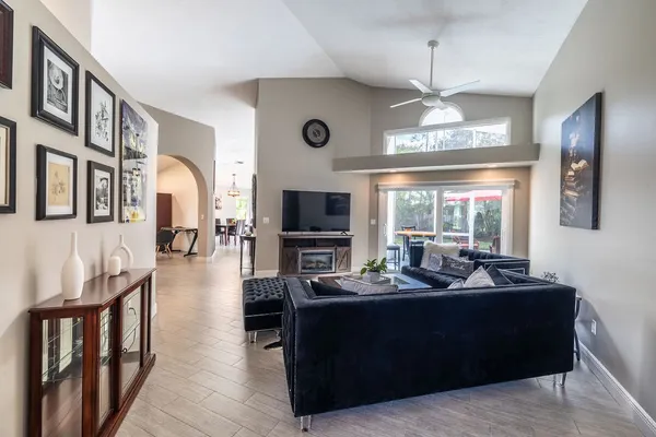 a living room with furniture wooden floor and a flat screen tv