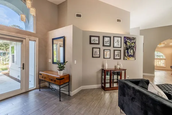 a living room with furniture and wooden floor