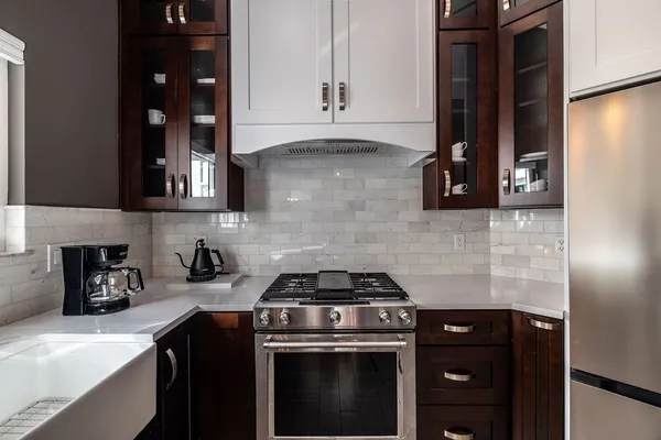 a kitchen with a stove and cabinets