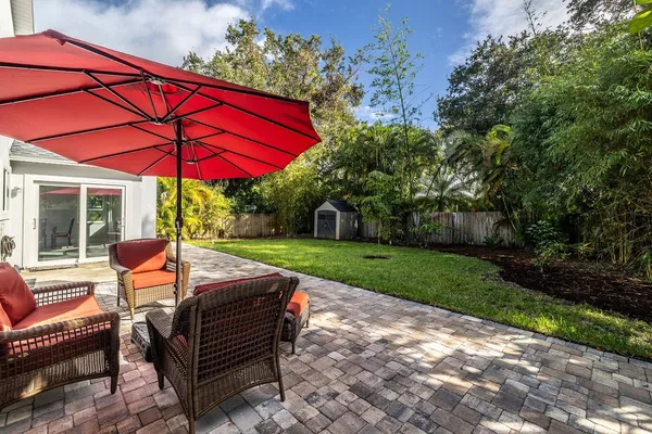 a view of a sitting area with furniture in backyard