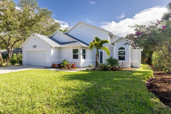 a front view of a house with a garden and porch