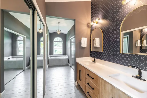 a bathroom with a double vanity sink and a mirror