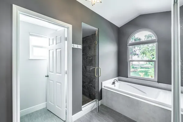 a bathroom with a bathtub and a shower