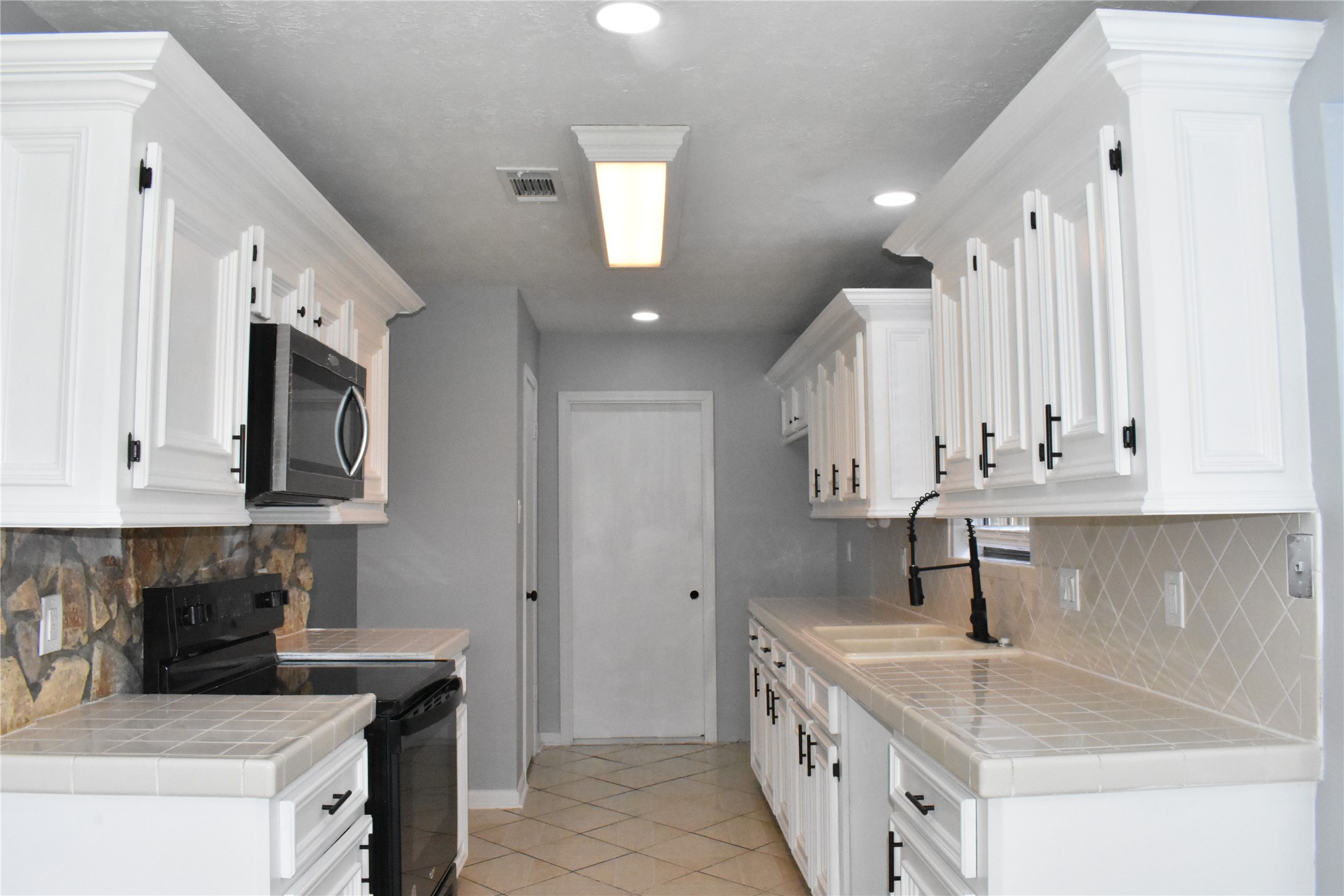 1347 Somercotes Lane Channelview, TX 77530 - Photo 12 of 30 a kitchen with stainless steel appliances granite countertop a sink stove and cabinets
