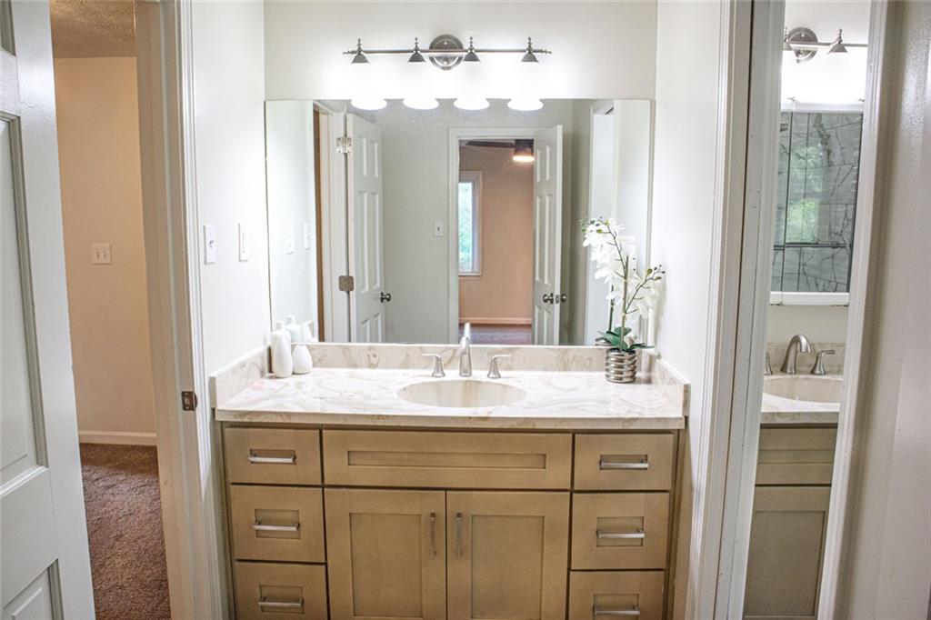 4970 Hull Road Southeast Conyers, GA 30094 - Photo 16 of 25 a bathroom with a sink and a mirror