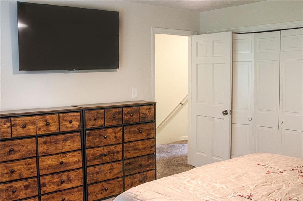 4970 Hull Road Southeast Conyers, GA 30094 - Photo 23 of 25 a bedroom with a bed and a flat screen tv