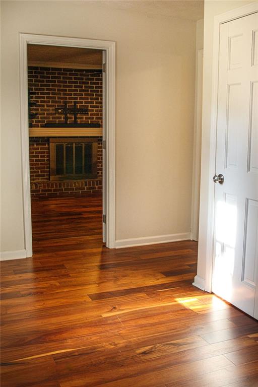 4970 Hull Road Southeast Conyers, GA 30094 - Photo 5 of 25 a view of an empty room with wooden floor and a window