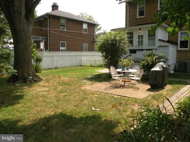 805 Russell Road Alexandria, VA 22301 - Photo 14 of 27 a view of the house with backyard and sitting area
