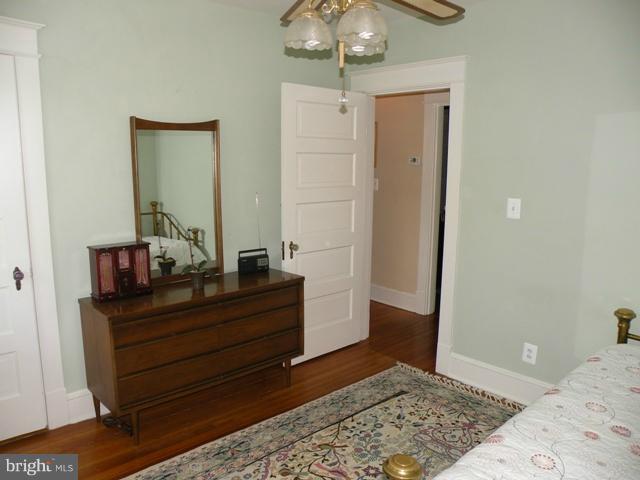 805 Russell Road Alexandria, VA 22301 - Photo 17 of 27 a bedroom with a bed and a mirror on dresser