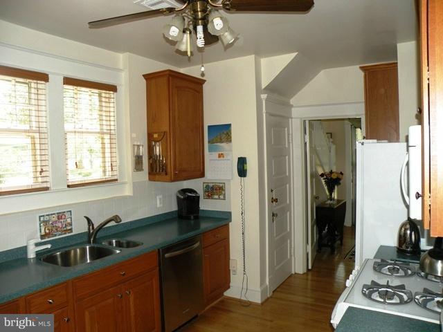805 Russell Road Alexandria, VA 22301 - Photo 19 of 27 a kitchen with stainless steel appliances granite countertop a sink dishwasher a refrigerator and a stove with wooden floor