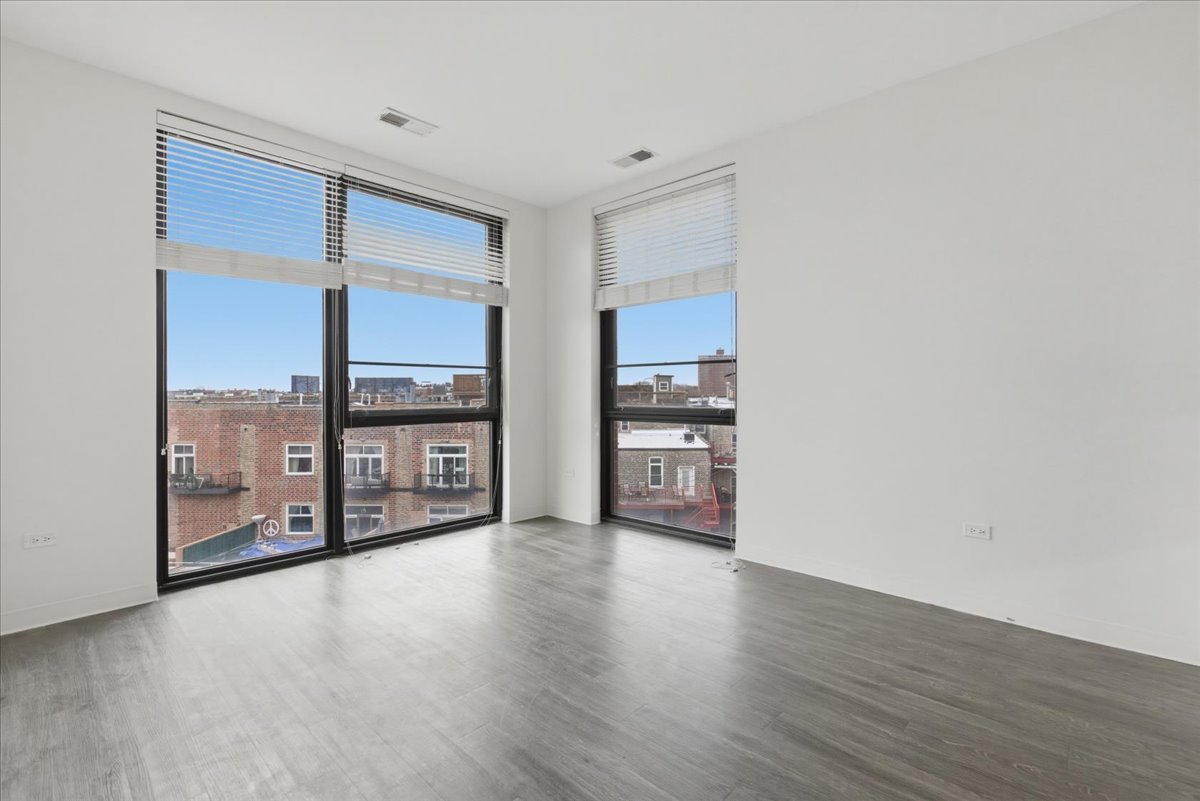 830 North Milwaukee Avenue, Unit 506 Chicago, IL 60642 - Photo 5 of 15 a view of a kitchen with a sink and a large window