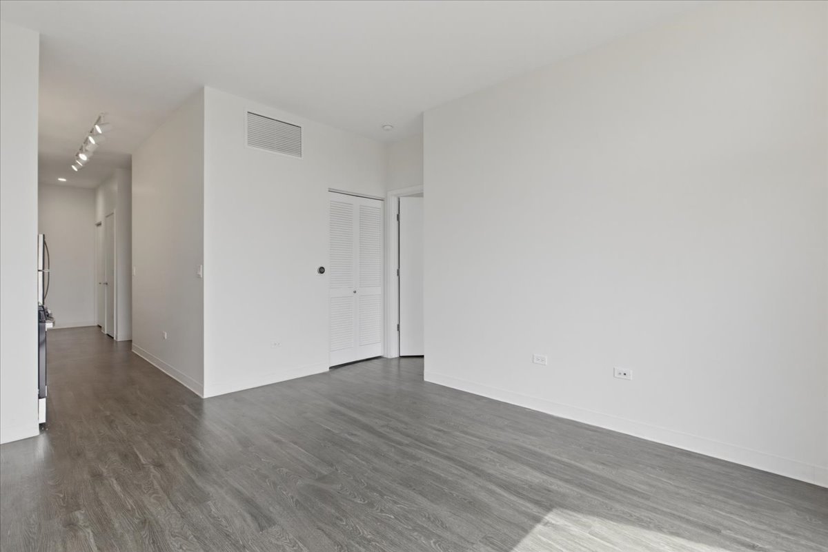 830 North Milwaukee Avenue, Unit 506 Chicago, IL 60642 - Photo 6 of 15 a view of an empty room with wooden floor