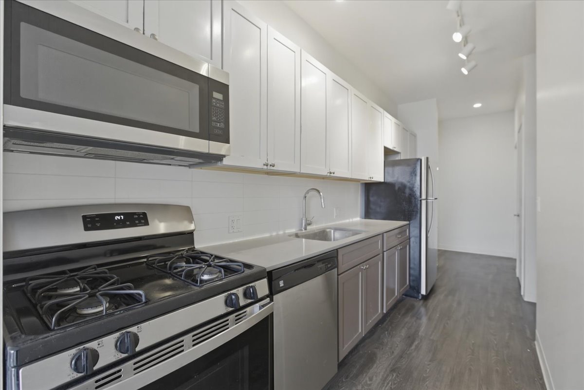 830 North Milwaukee Avenue, Unit 506 Chicago, IL 60642 - Photo 7 of 15 a kitchen with a stove and a microwave