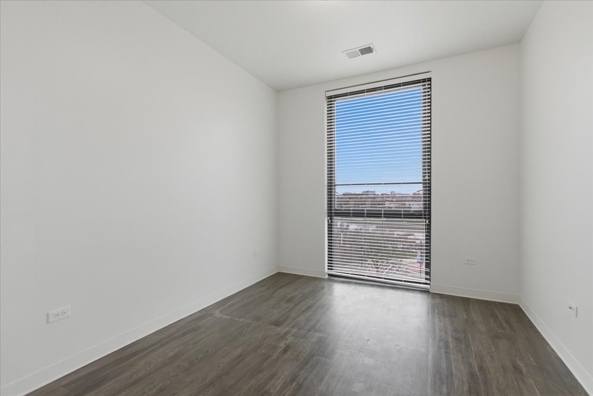 830 North Milwaukee Avenue, Unit 506 Chicago, IL 60642 - Photo 8 of 15 wooden floor in an empty room