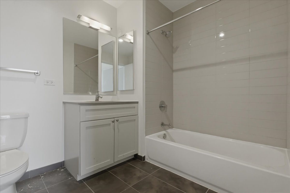 830 North Milwaukee Avenue, Unit 506 Chicago, IL 60642 - Photo 9 of 15 a bathroom with a sink a toilet and shower