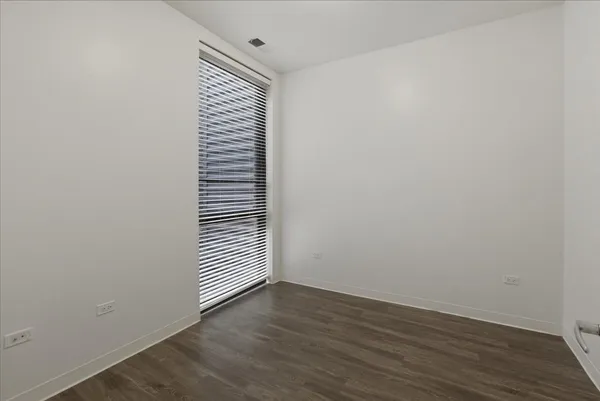 a view of a room with wooden floor and window