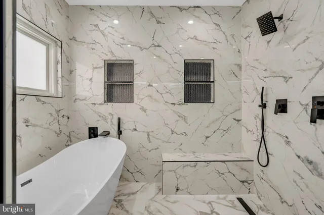 a bathroom with a bathtub and a shower