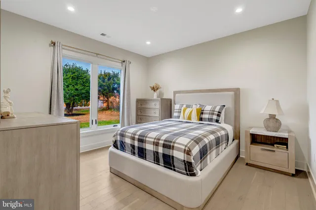 a bedroom with a large bed and a window