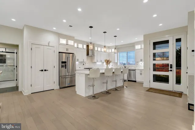 a view of a kitchen with furniture and refrigerator