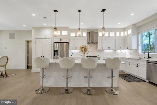 a large kitchen with a table and chairs