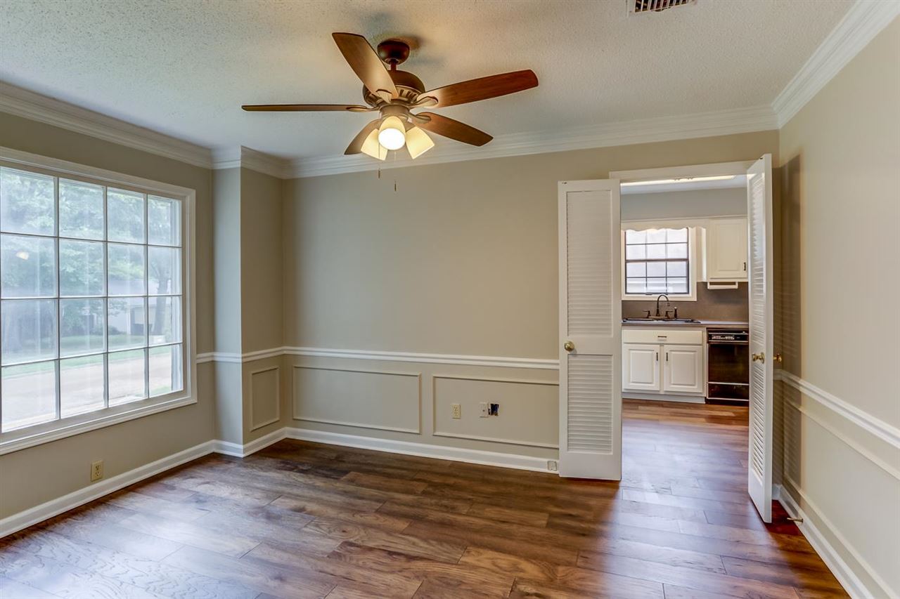 445 Dove Valley Road Collierville, TN 38017 - Photo 2 of 24 a view of a livingroom with wooden floor and a ceiling fan