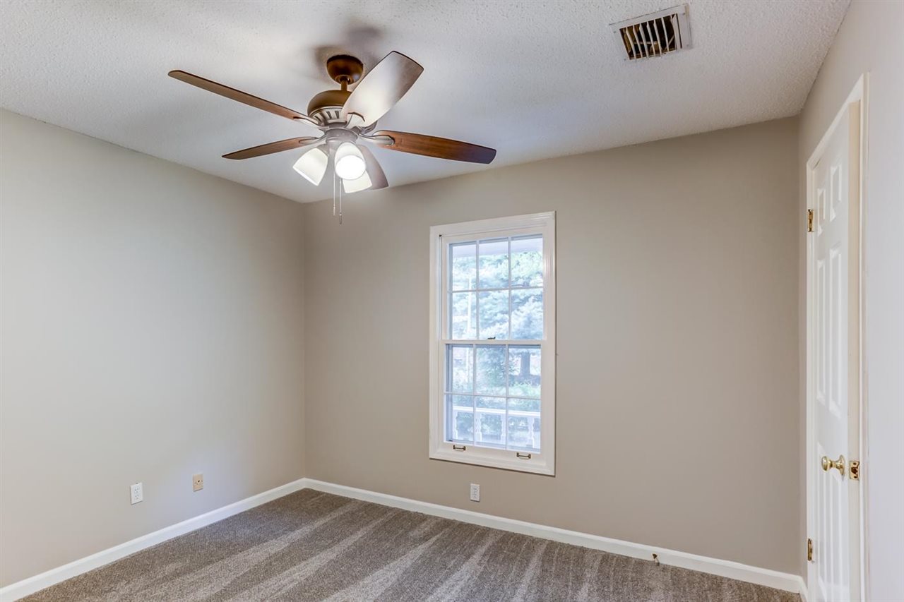 445 Dove Valley Road Collierville, TN 38017 - Photo 15 of 24 wooden floor in an empty room with a window