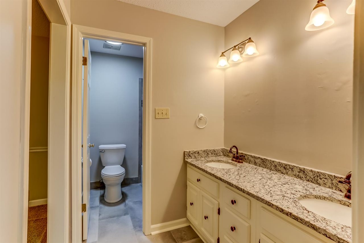 445 Dove Valley Road Collierville, TN 38017 - Photo 19 of 24 a bathroom with a granite countertop sink and a mirror