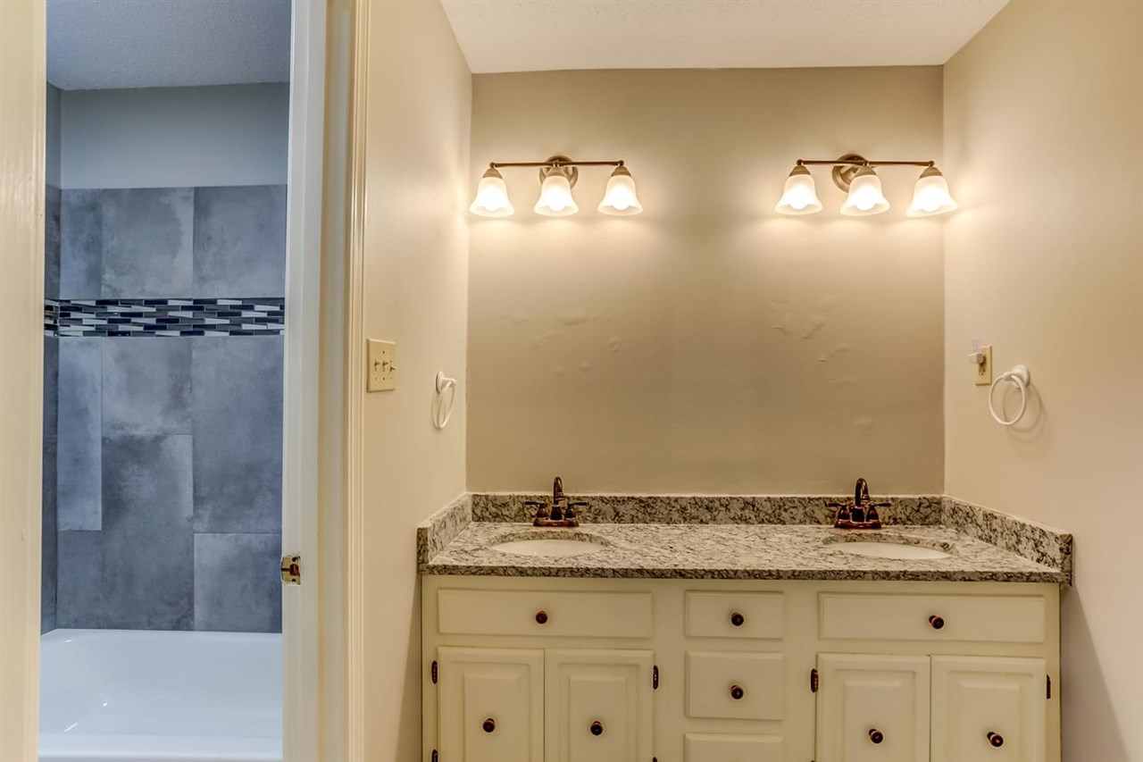 445 Dove Valley Road Collierville, TN 38017 - Photo 20 of 24 a bathroom with a granite countertop sink and a mirror