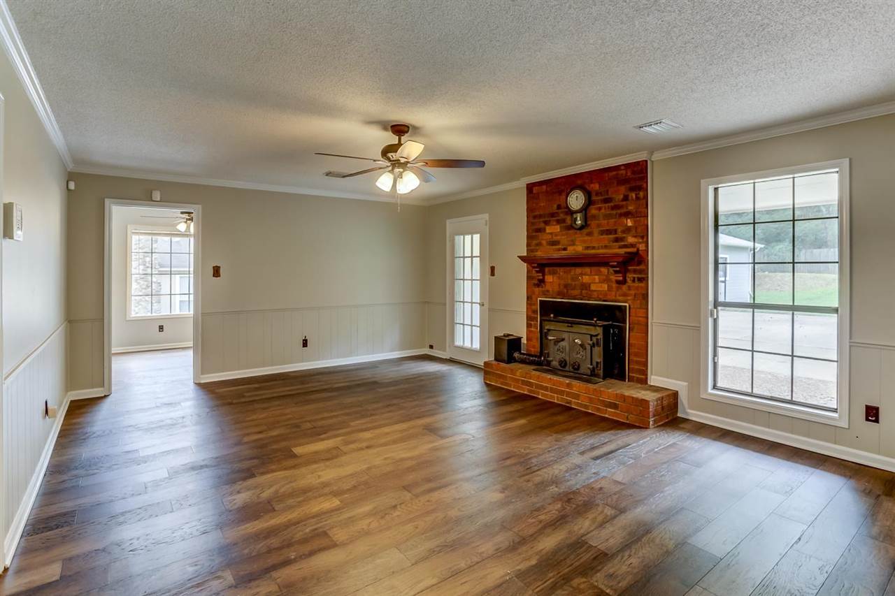 445 Dove Valley Road Collierville, TN 38017 - Photo 6 of 24 wooden floor fireplace and windows in an empty room