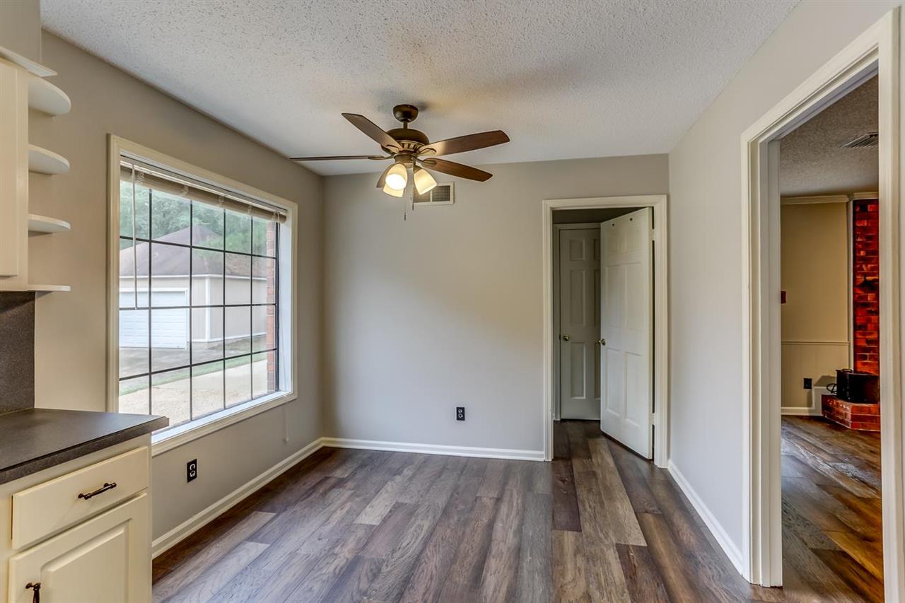 445 Dove Valley Road Collierville, TN 38017 - Photo 9 of 24 a view of an empty room with a window and wooden floor