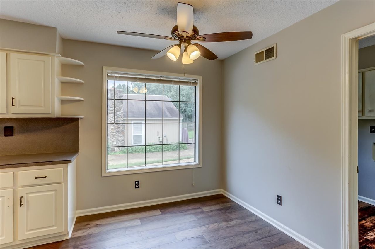 445 Dove Valley Road Collierville, TN 38017 - Photo 10 of 24 a view of an empty room with a window and wooden floor