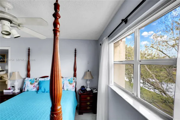 a bedroom with furniture and a flat screen tv