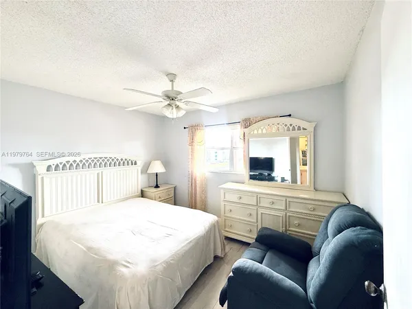 a living room with furniture a chandelier and a flat screen tv