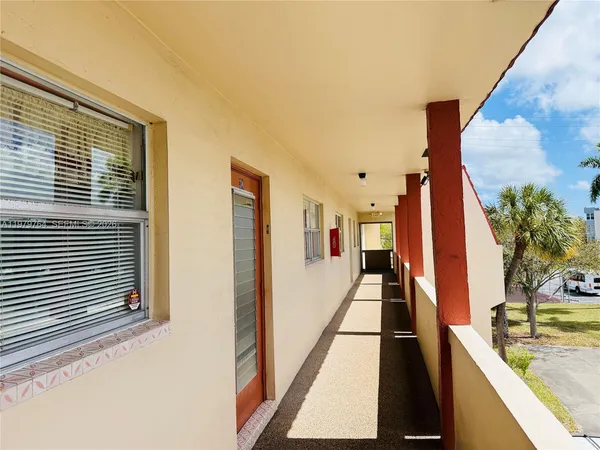 a view of a living room with a balcony and mountain view