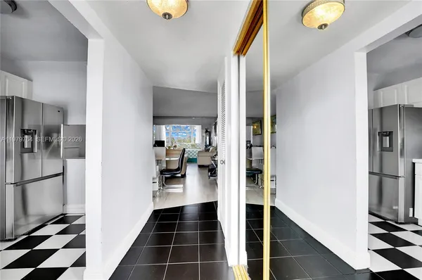 a walk in closet with window and stainless steel appliances