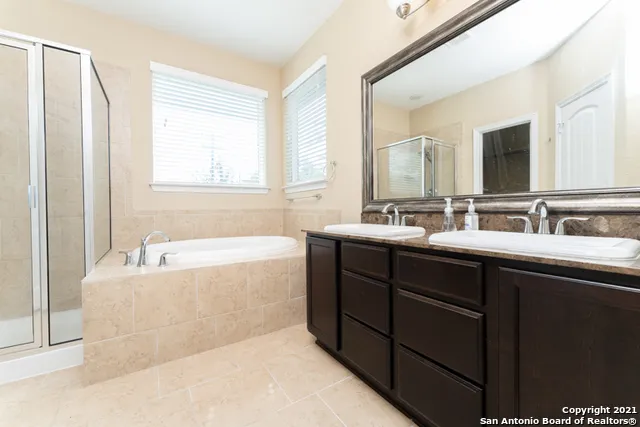 a white bath tub sitting in a bathroom next to a window
