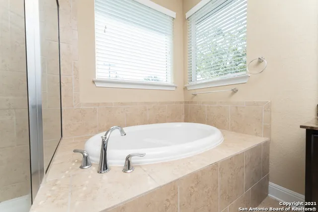 a white bath tub sitting next to a white sink