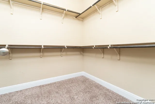 a bathroom with a granite countertop sink toilet a mirror and shower