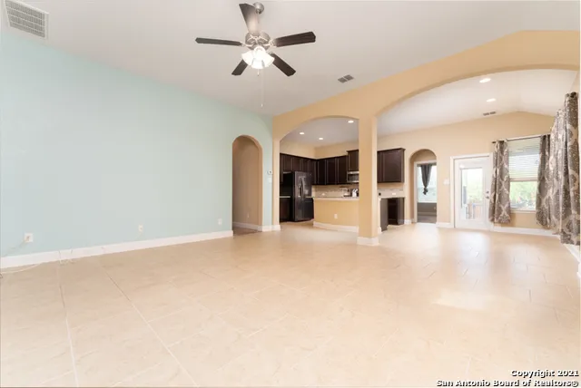 an empty room with closet and a chandelier fan