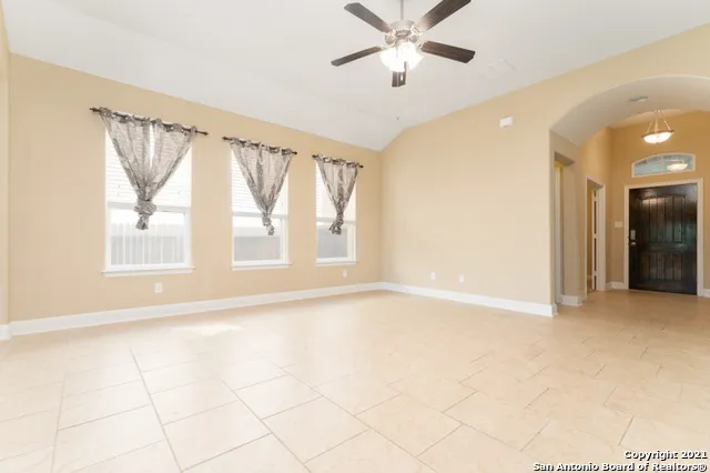 a kitchen with kitchen island granite countertop a stove a refrigerator a sink a oven and a refrigerator with wooden floor