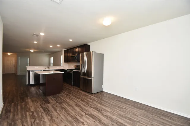 a large kitchen with a sink and stainless steel appliances