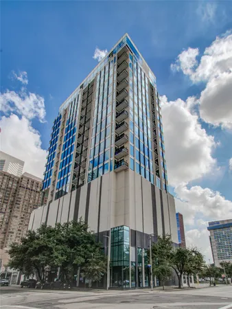 a view of a tall building next to a road